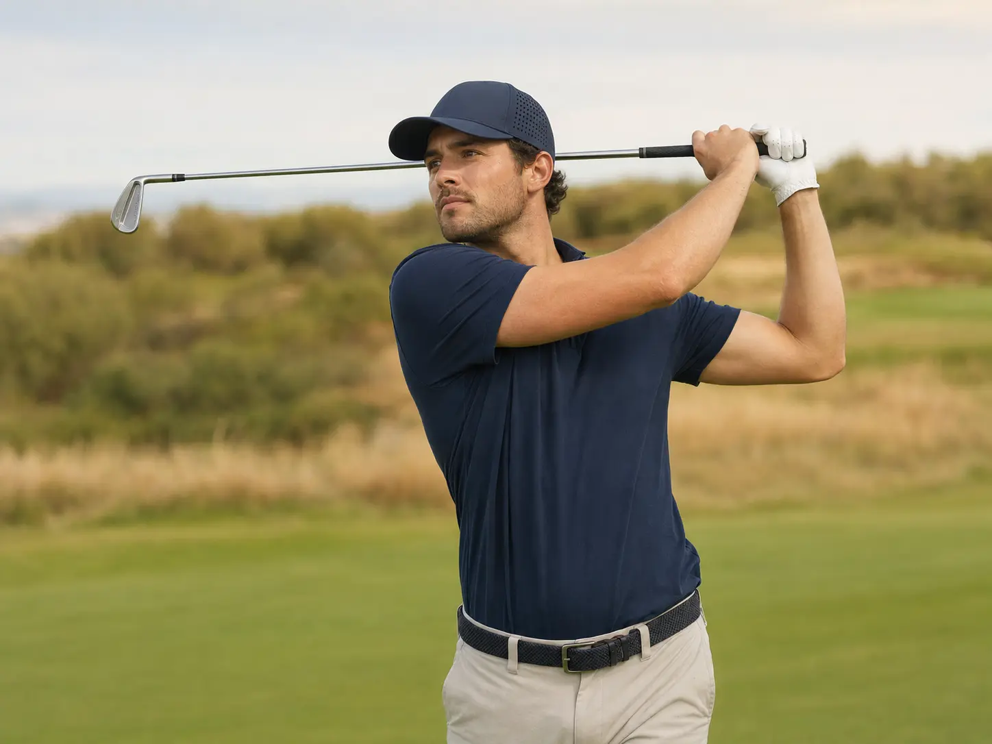 Golfer wearing a laser-perforated performance cap